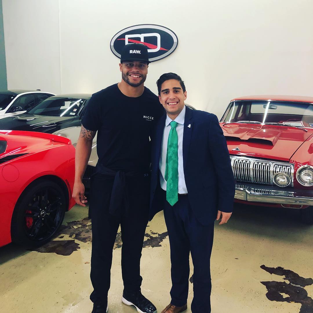 Dak Prescott × RDAG… dealership floor, suit-and-tie days.